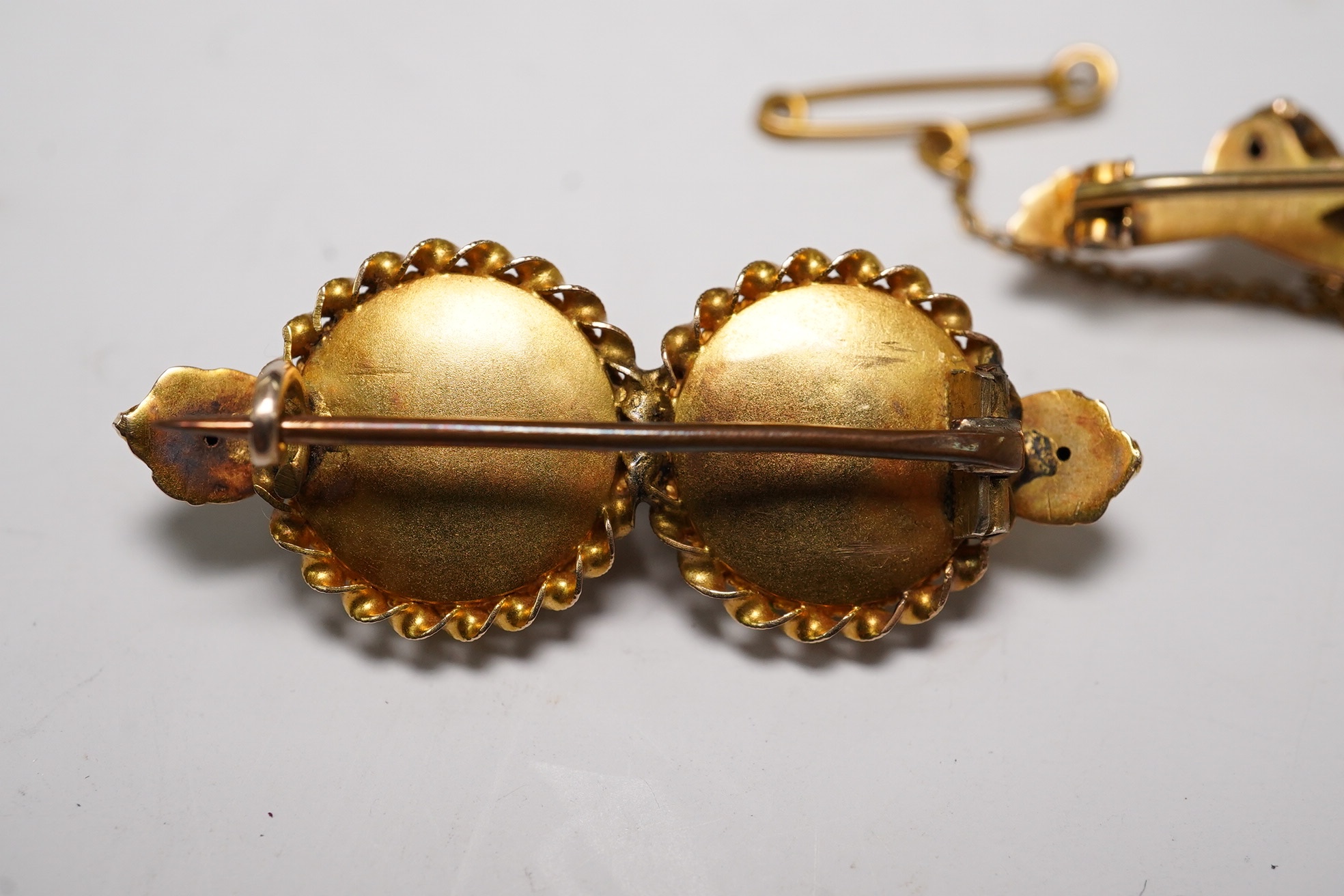 An Edwardian 9ct gold, hessonite garnet and seed pearl cluster set bar brooch, 42mm and a Victorian yellow metal, garnet and seed pearl set bar brooch, gross weight 7.3 grams, Condition - fair to good